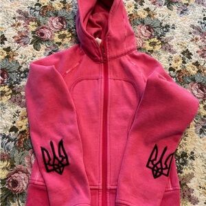 Pink Lululemon Hoodie with Black Tryzub Design Embroidered on sleeves.